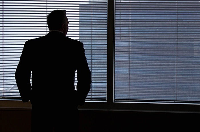 the back of a man in a suit, windows, window blinds