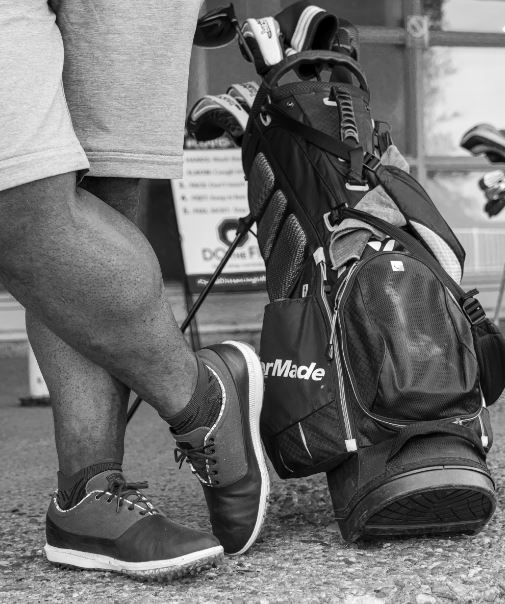 A person standing near a stand bag