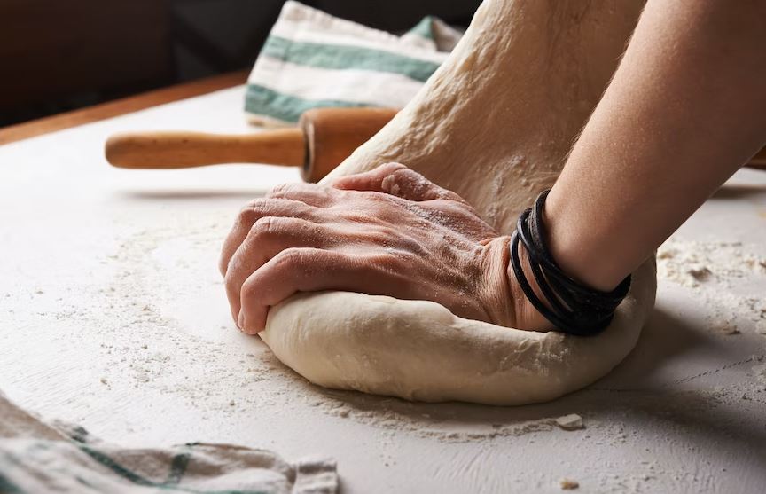 Person making dough on a mat