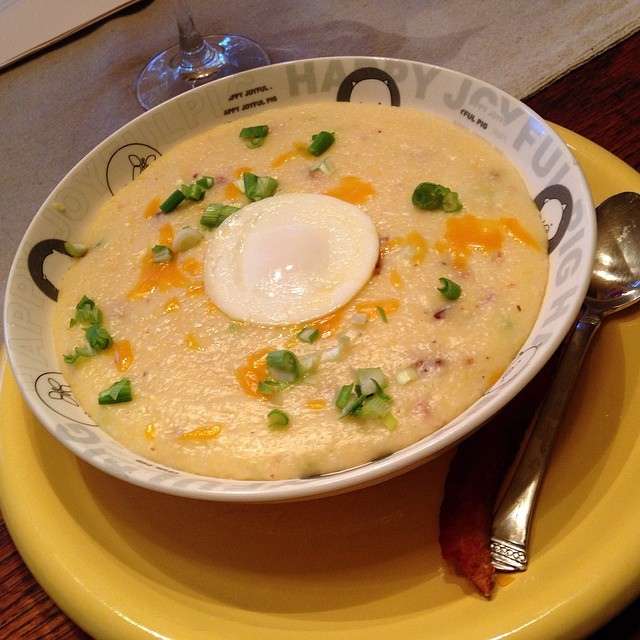 Grits with cheese, bacon,  green onion and a basted egg