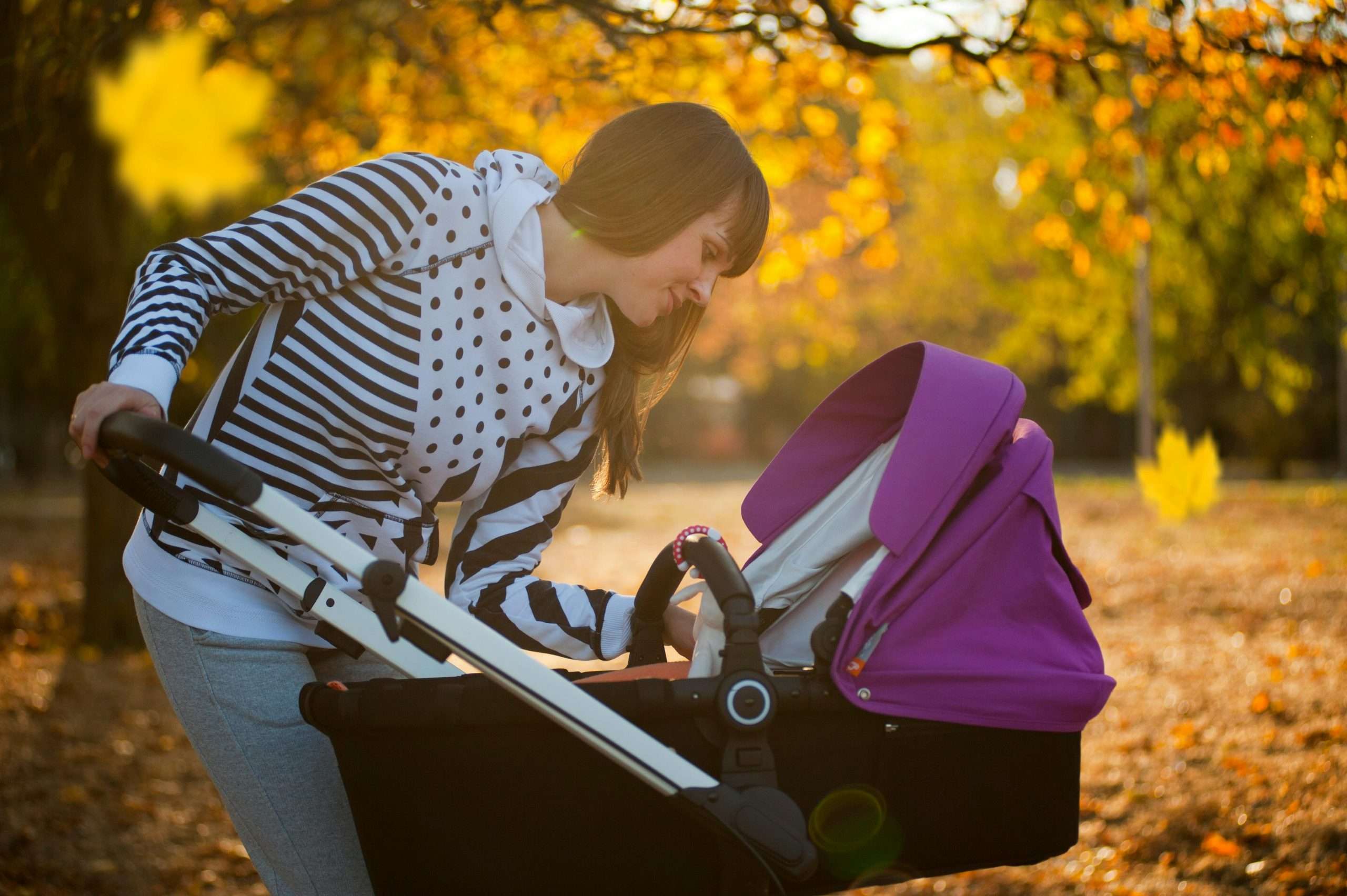 photo of a woman looking at her baby