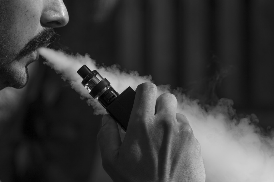 man using a vaping device